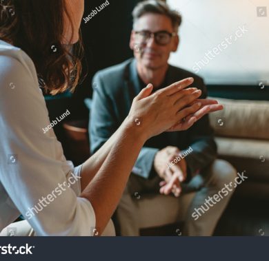 stock-photo-two-business-people-discussing-in-office-lounge-businesswoman-talking-with-a-male-colleague-in-1702602871